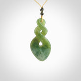 Hand carved New Zealand jade twist pendant. Carved in New Zealand by NZ Pacific. Unique double twist jewellery for sale online. Provided with an adjustable oat coloured cord.